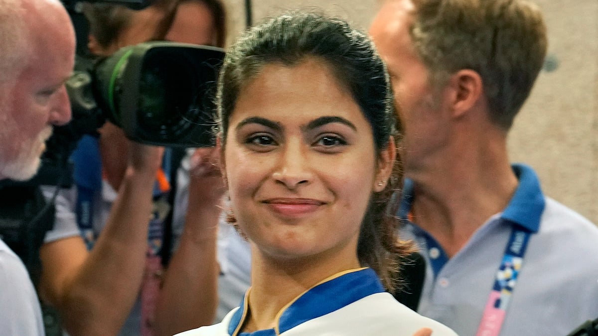 (AP Photo/Manish Swarup) : India's Manu Bhaker gestures after winning the bronze medal in the 10m air pistol mixed team event with Sarabjot Singh at the 2024 Summer Olympics, Tuesday, July 30, 2024, in Chateauroux, France. 